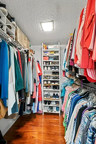 a view of walk in closet with clothes
