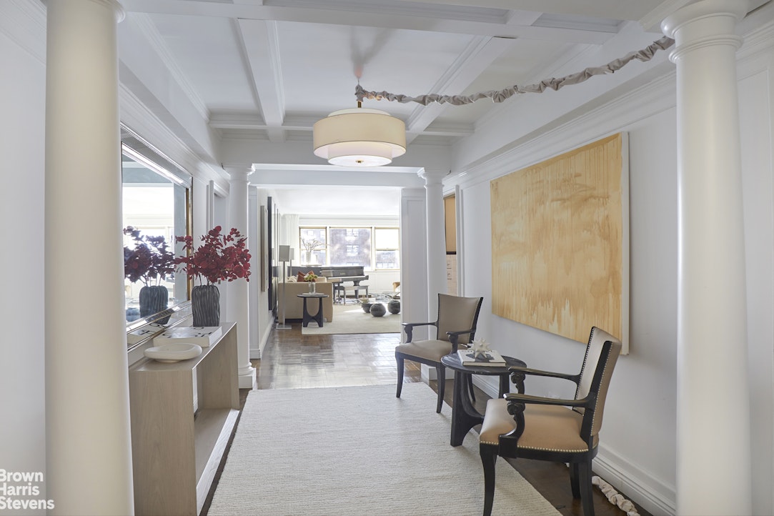 415 East 52nd Street, Unit 6GC Manhattan, NY 10022 - Photo 1 of 15 a living room with furniture and a chandelier