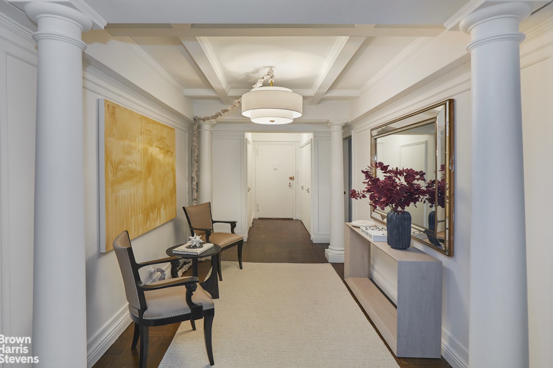 415 East 52nd Street, Unit 6GC Manhattan, NY 10022 - Photo 14 of 15 a bedroom with a bed and a chandelier