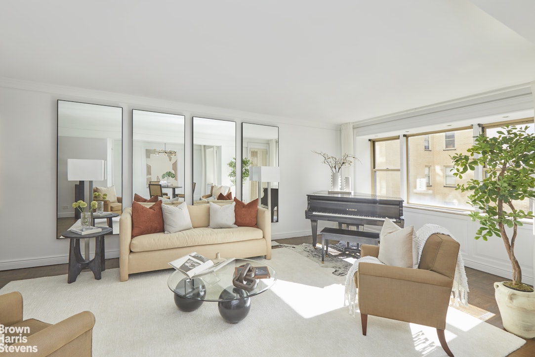 415 East 52nd Street, Unit 6GC Manhattan, NY 10022 - Photo 3 of 15 a living room with furniture and a large window