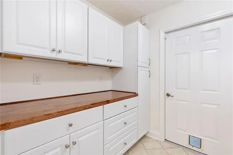 an empty room with windows and ceiling fan