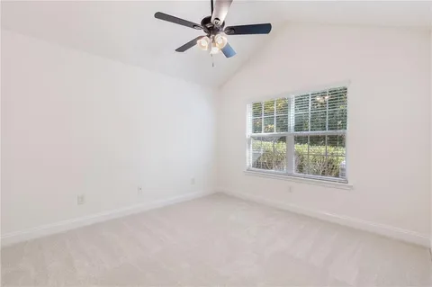 a spacious bathroom with a double vanity sink toilet and a mirror