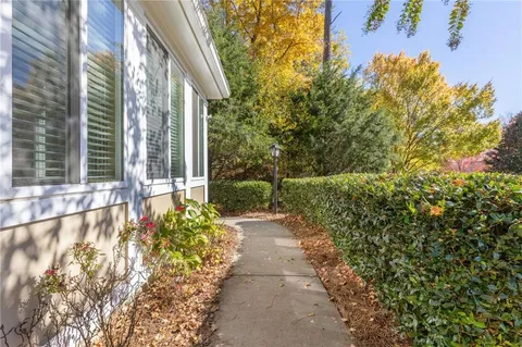 a view of a pathway of a house with a yard