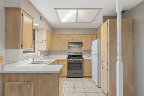a kitchen with a sink appliances and cabinets