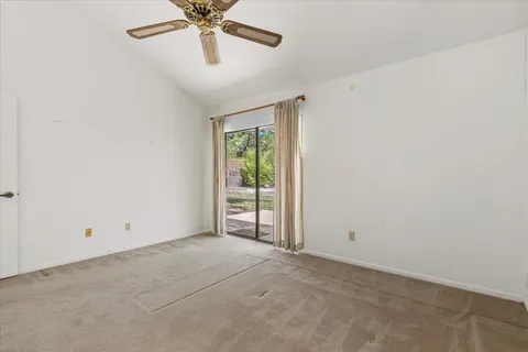 a view of a livingroom with a ceiling fan and hardwood floor