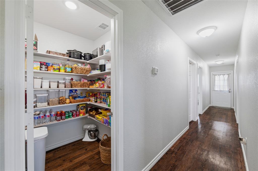 300 West Main Street Itasca, TX 76055 - Photo 13 of 31 a view of walk in closet with clothes and shoes