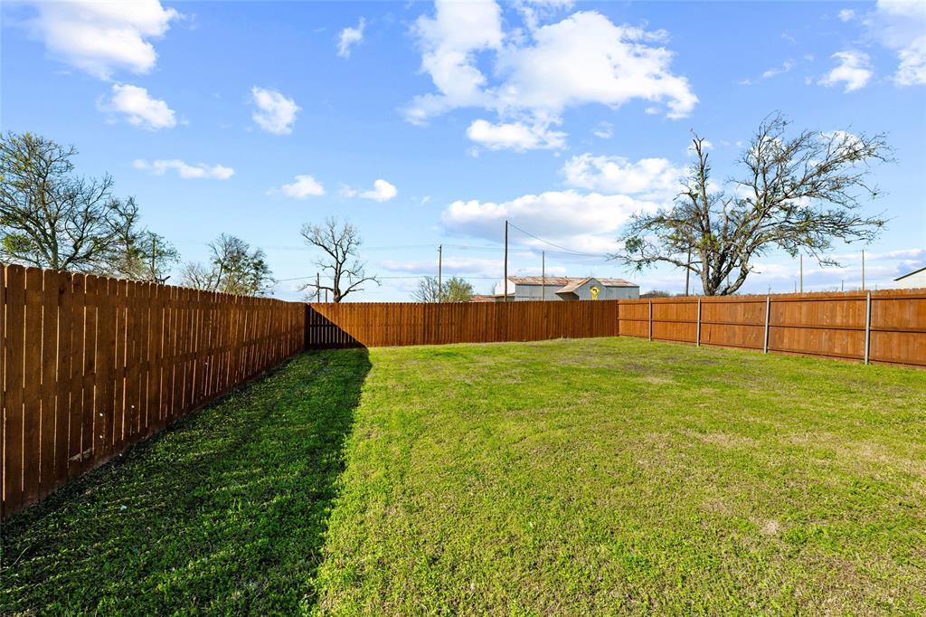 300 West Main Street Itasca, TX 76055 - Photo 16 of 31 a view of yard with swimming pool and green space