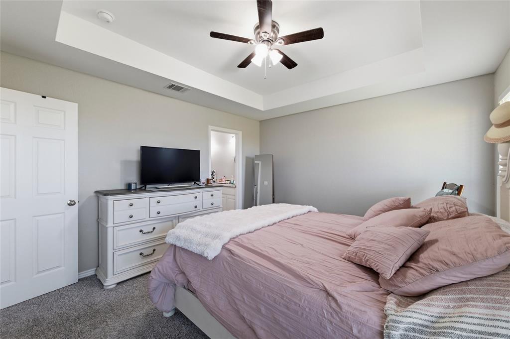 300 West Main Street Itasca, TX 76055 - Photo 21 of 31 a bedroom with a bed and a flat screen tv
