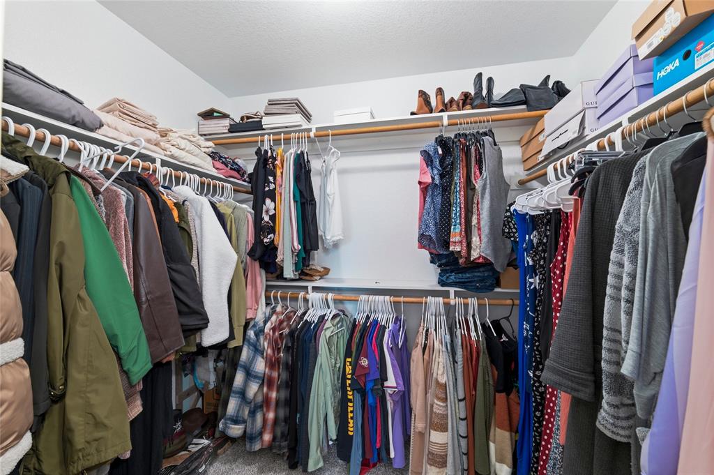 300 West Main Street Itasca, TX 76055 - Photo 22 of 31 a view of walk in closet with clothes and shoes