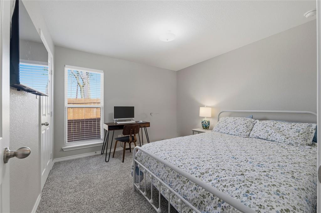 300 West Main Street Itasca, TX 76055 - Photo 24 of 31 a bedroom with a bed and a table in it