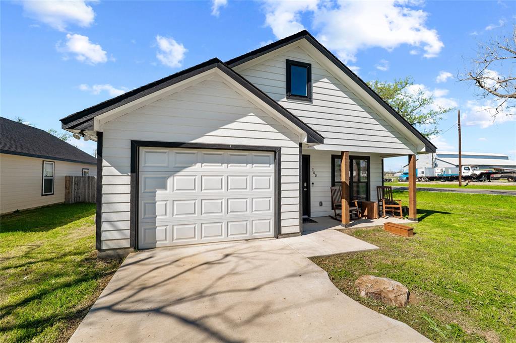 300 West Main Street Itasca, TX 76055 - Photo 3 of 31 a front view of a house with a yard outdoor seating and garage