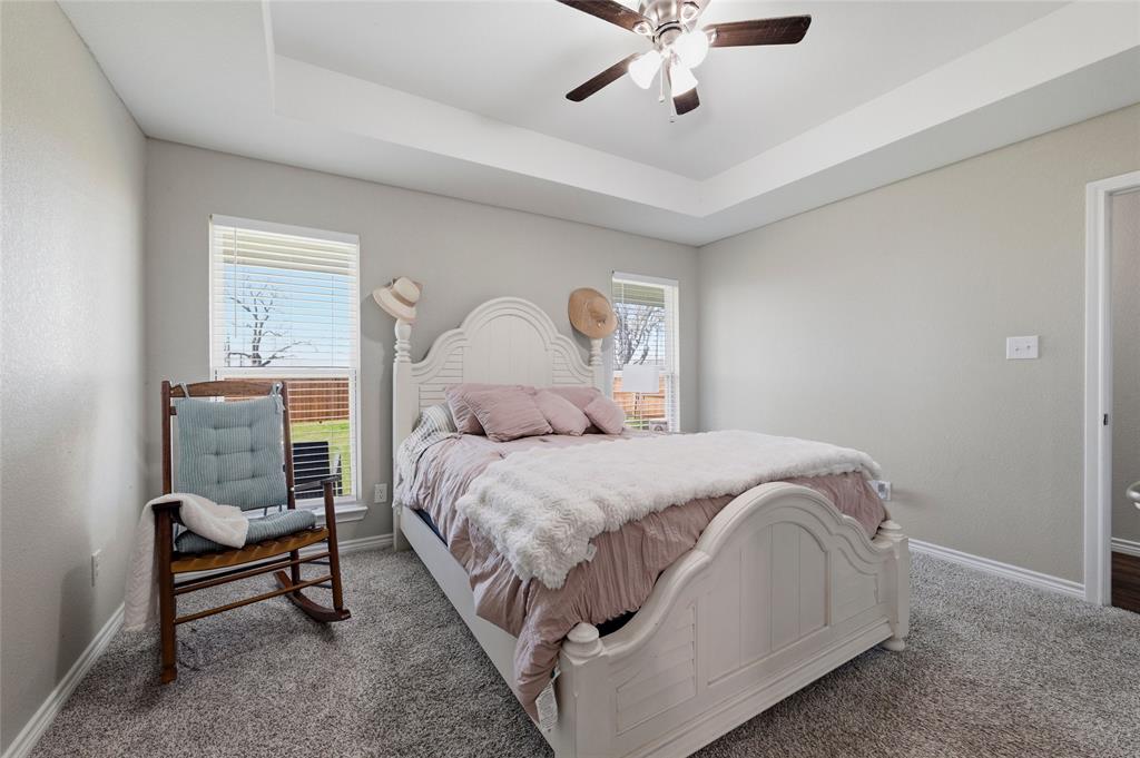 300 West Main Street Itasca, TX 76055 - Photo 9 of 31 a bedroom with a bed and a chandelier