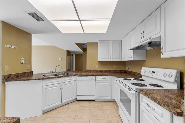 a kitchen with a refrigerator and a sink