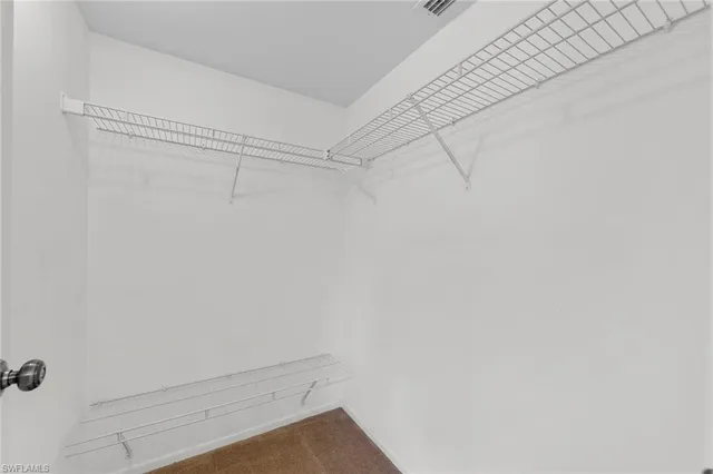 an empty room with a ceiling fan and a window