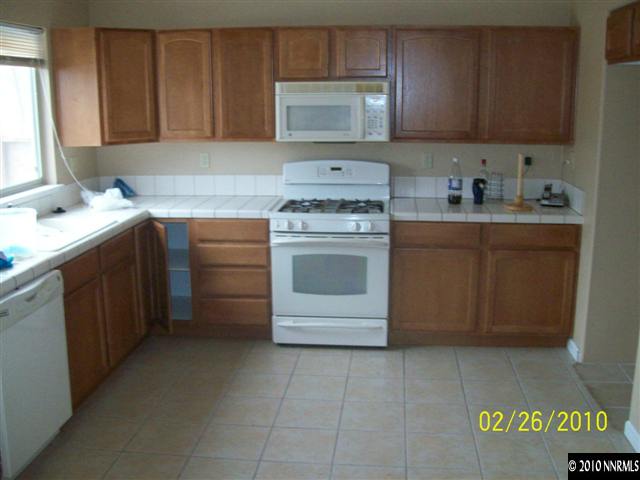 9815 Meadowstar Drive Reno, NV 89506 - Photo 2 of 9 a kitchen with appliances cabinets and a window