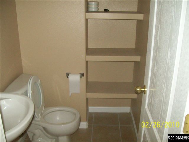 9815 Meadowstar Drive Reno, NV 89506 - Photo 4 of 9 a bathroom with a toilet and a sink
