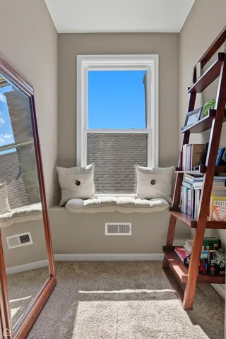 a view of living room with furniture and a book shelf