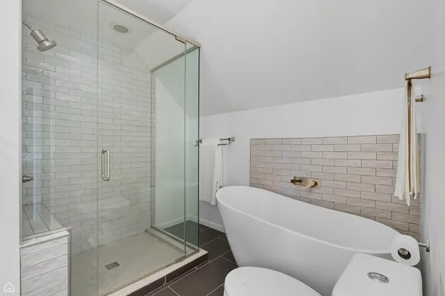 a bathroom with a toilet and shower