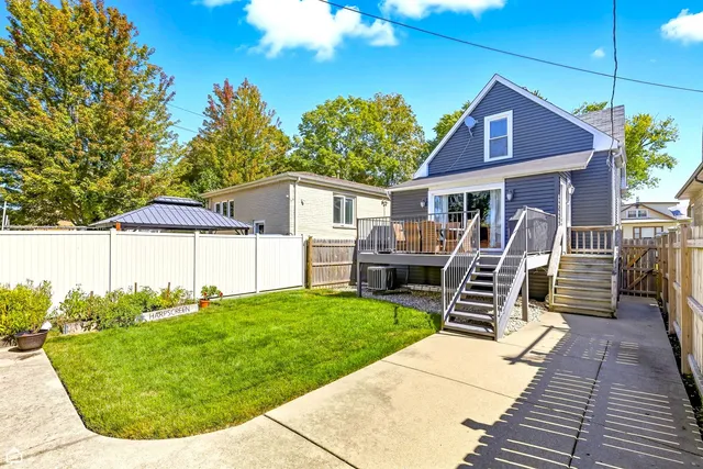 a view of a house with backyard porch and sitting area