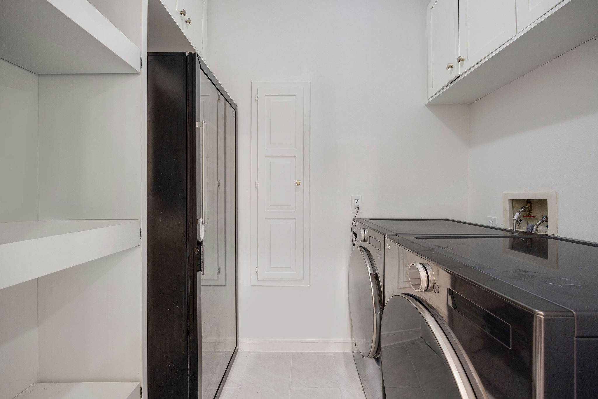 727 Bunker Hill Road, Unit 26 Houston, TX 77024 - Photo 11 of 25 The walk-in pantry features a wine fridge, shelving for all your storage needs and the washer/dryer, which stay with the rental.
