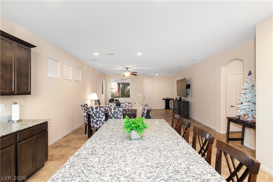2079 Port Royal Drive Laughlin, NV 89029 - Photo 20 of 86 Breakfast Bar in Kitchen with light tile patterned floors, a ceiling fan, and recessed lighting