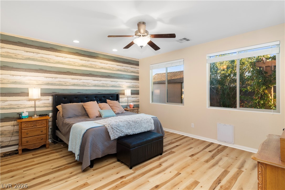 2079 Port Royal Drive Laughlin, NV 89029 - Photo 23 of 86 Primary Bedroom featuring wooden walls, an accent wall, ceiling fan, light wood finished floors, and recessed lighting