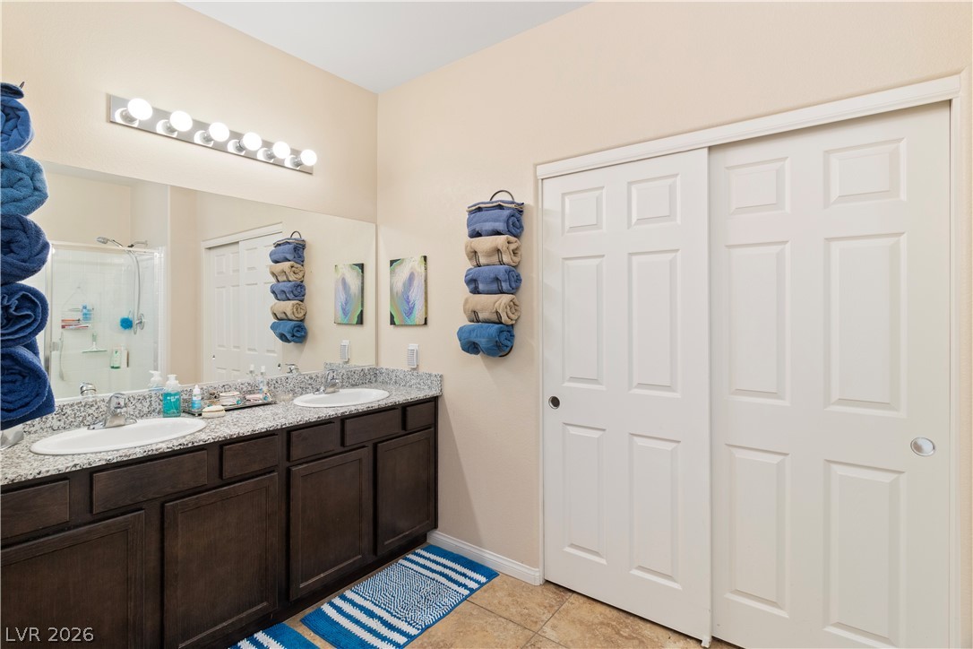 2079 Port Royal Drive Laughlin, NV 89029 - Photo 28 of 86 Primary Ensuite Bathroom featuring double vanity, a stall shower, and light tile patterned floors