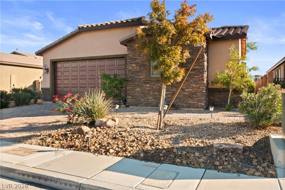 2079 Port Royal Drive Laughlin, NV 89029 - Photo 66 of 86 View of front of house featuring stone siding, stucco siding, a tiled roof, and decorative driveway