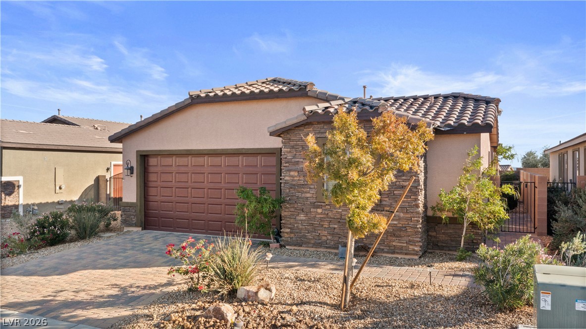 2079 Port Royal Drive Laughlin, NV 89029 - Photo 69 of 86 Mediterranean / spanish home featuring stucco siding, stone siding, decorative driveway, a tile roof, and an attached garage