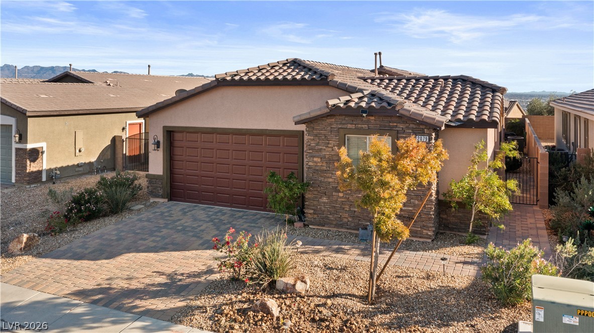 2079 Port Royal Drive Laughlin, NV 89029 - Photo 70 of 86 View of front of property with stucco siding, a gate, decorative driveway, and stone siding