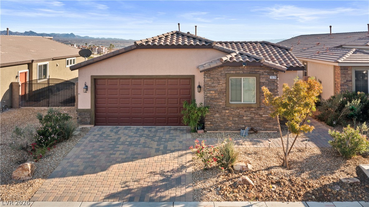 2079 Port Royal Drive Laughlin, NV 89029 - Photo 71 of 86 Mediterranean / spanish home with stone siding, stucco siding, decorative driveway, a tiled roof, and a garage