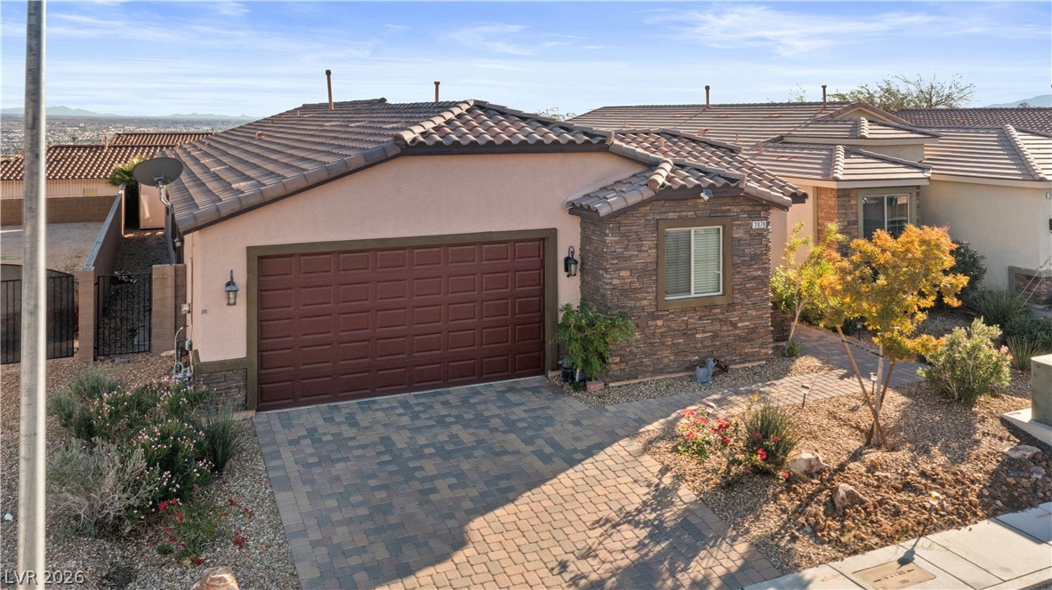 2079 Port Royal Drive Laughlin, NV 89029 - Photo 72 of 86 View of front facade featuring stone siding, stucco siding, and a garage