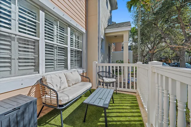a view of a balcony with two chairs and a wooden floor