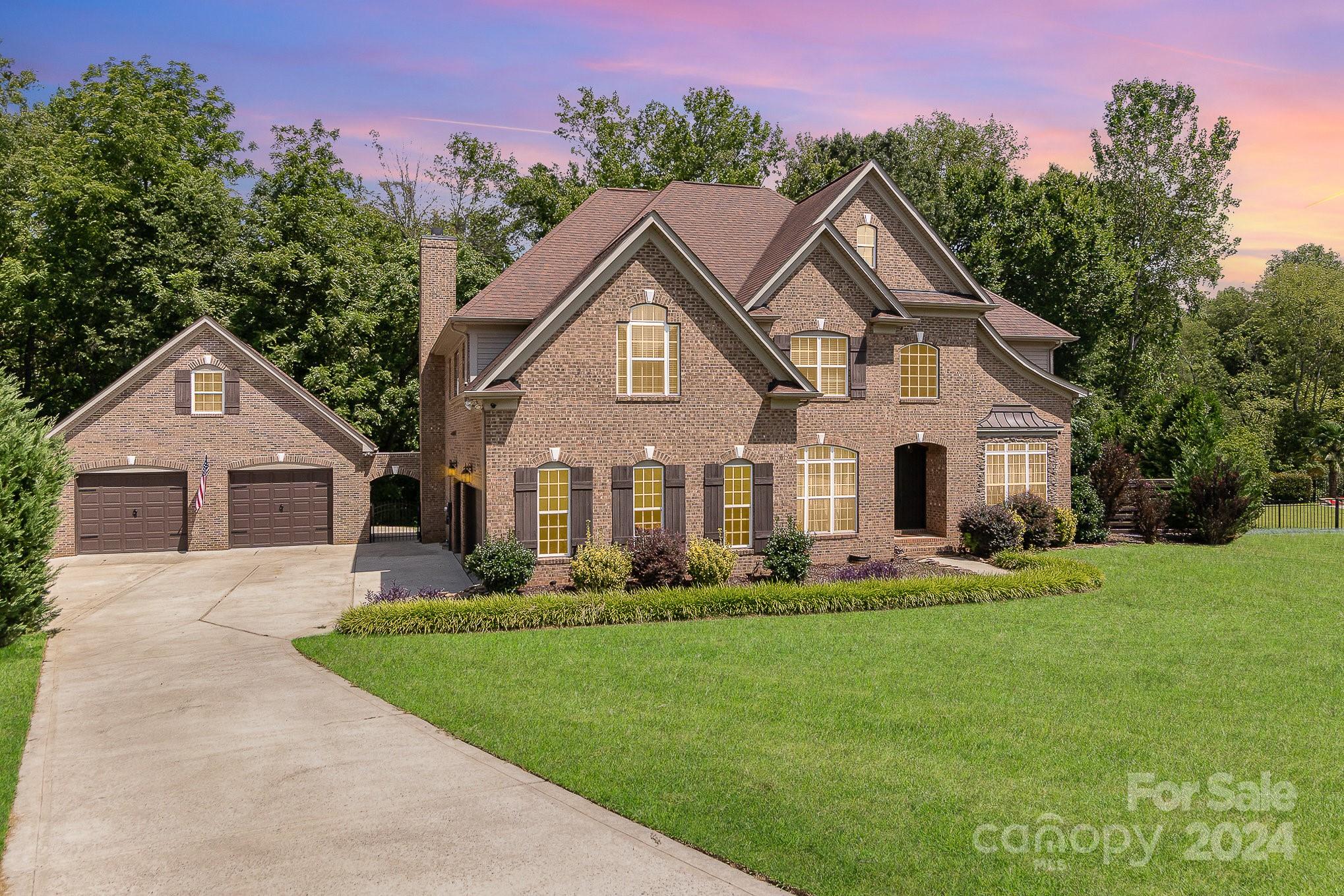 a front view of house with yard and green space