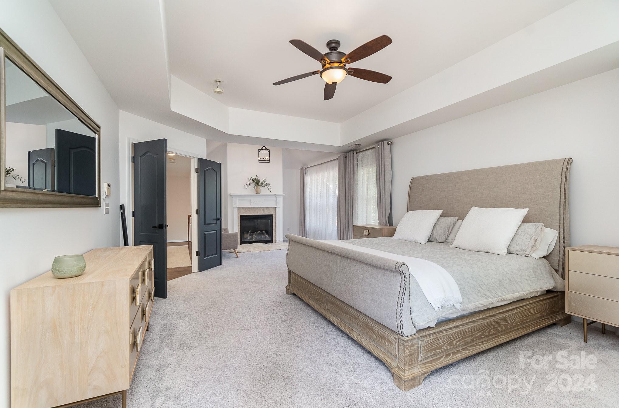 2070 Applebrook Drive Monroe, NC 28110 - Photo 10 of 35 a bedroom with a large bed a flat screen tv and couches