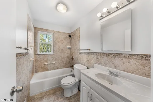 a bathroom with a sink a toilet and bathtub