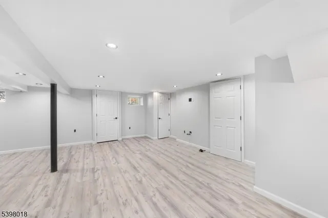 a view of an empty room and wooden floor