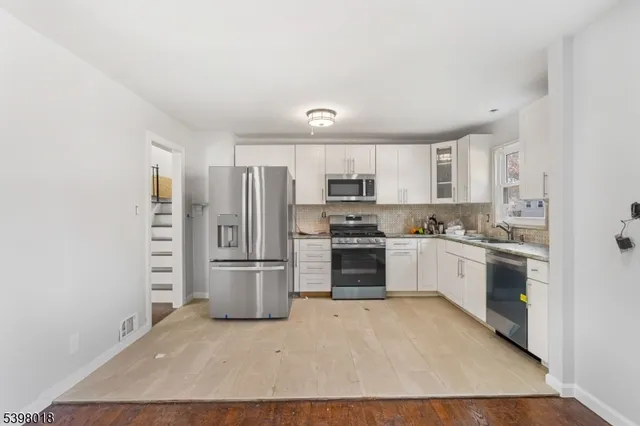 a kitchen with a refrigerator cabinets and stainless steel appliances