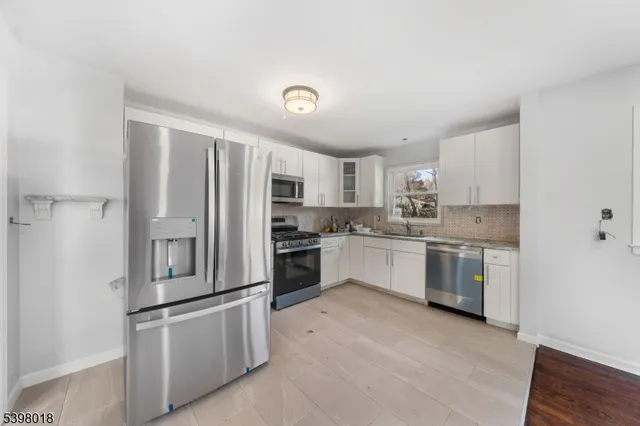 a kitchen with stainless steel appliances and white cabinets