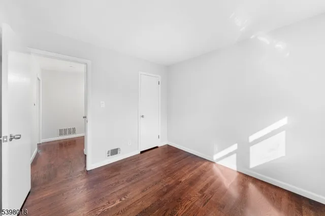 an empty room with wooden floor