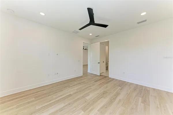 a view of a room with wooden floor and windows
