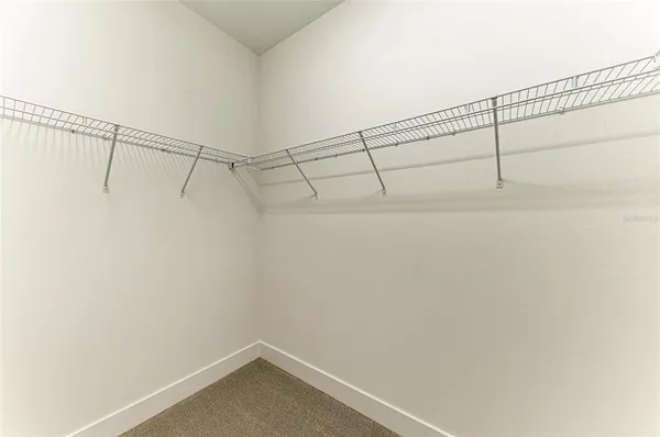 an empty room with a window and a ceiling fan