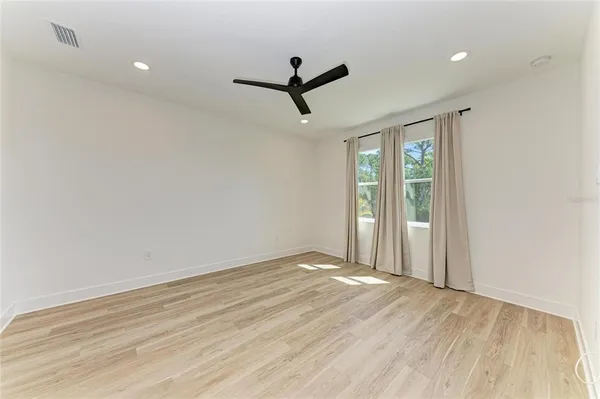 a view of a room with wooden floor and white walls