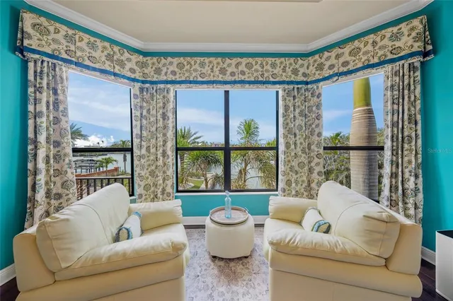 a dining room with furniture and a floor to ceiling window