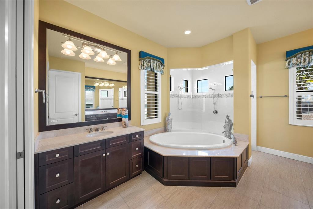 471 Bayshore Road Nokomis, FL 34275 - Photo 20 of 95 a bathroom with a tub sink and mirror