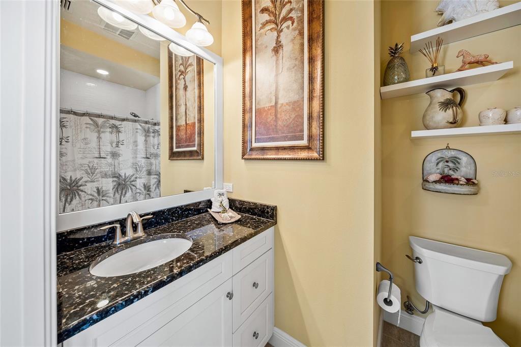471 Bayshore Road Nokomis, FL 34275 - Photo 25 of 95 a bathroom with a granite countertop sink and a mirror