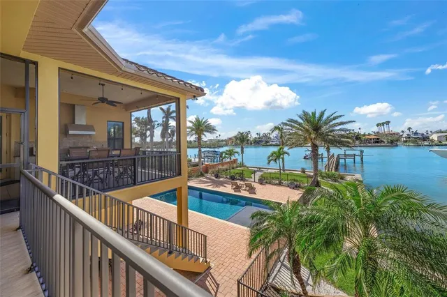 a kitchen with stainless steel appliances a stove a sink cabinets and a dining table