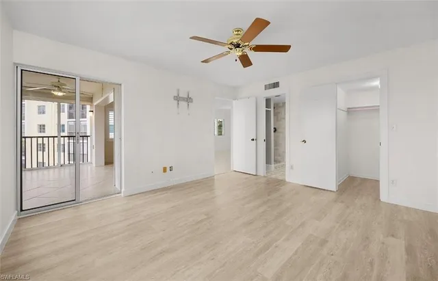 a view of a livingroom with a ceiling fan & entryway