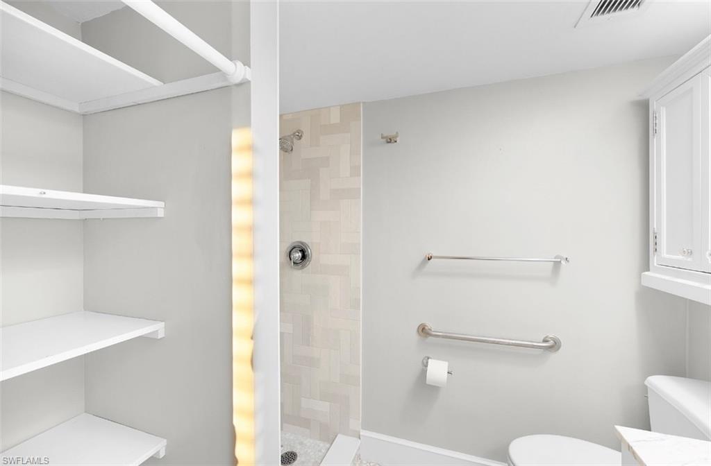 29 High Point Circle East, Unit 308 Naples, FL 34103 - Photo 19 of 39 a bathroom with a shower and a toilet