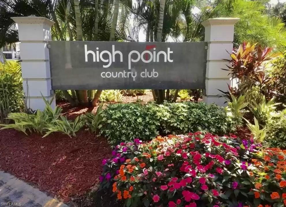 29 High Point Circle East, Unit 308 Naples, FL 34103 - Photo 27 of 39 a sign broad in front of flowers